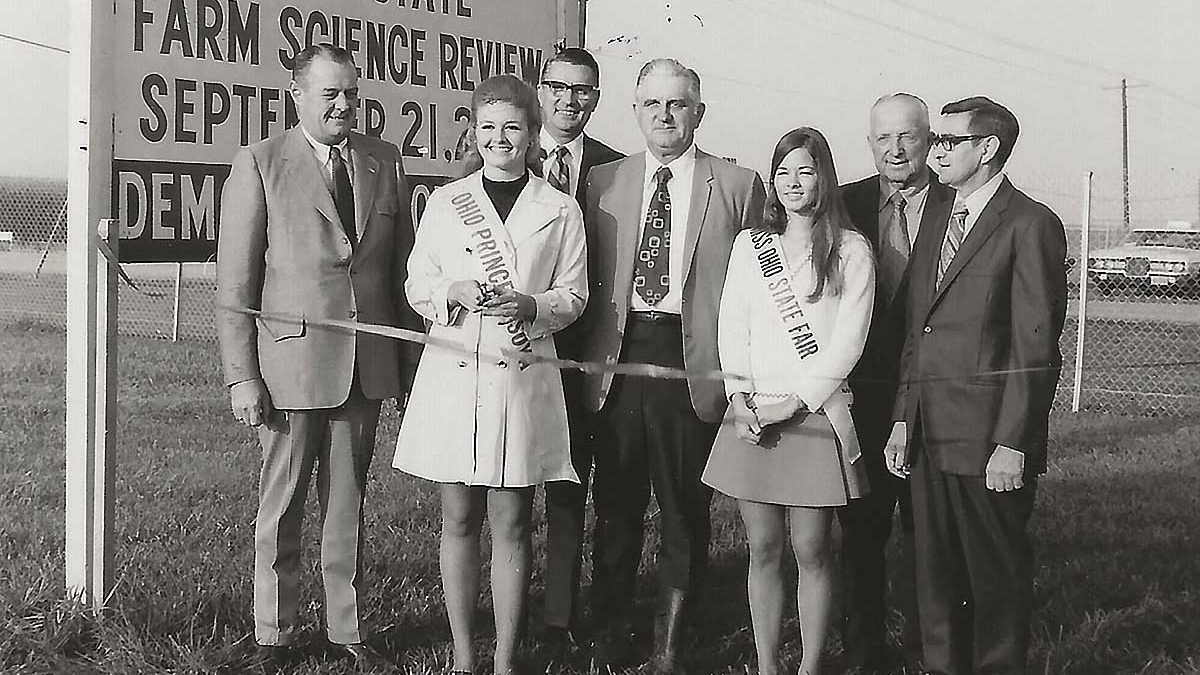 Ohio’s Princess Soya Teresa Ludwig cut the ribbon for the opening of the 1971 Ohio Farm Science Review at Columbus. Approximately 70,000 farmers saw the over 100 demonstration plots of corn and soybeans during the 3-day session. A tour of next year’s demonstrations will feature the annual American Soybean Association convention in Columbus in 1972. From left in the photo: M. David Urmston, deputy director, Ohio Department of Agriculture; Miss Ludwig; Dean Roy M. Kottman, Ohio State University College of Agriculture; Everett G. Royer, secretary-treasurer, Ohio Soybean Association; Connie Lett, Miss Ohio State Fair; Ed Sheid, member of the Ohio Expositions Commission; and Lawton McClintock, agriculture supervisor, Ohio State Fair.